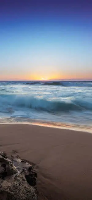 A serene iPhone X wallpaper capturing the beauty of the beach