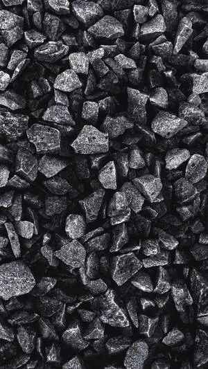 A sleek Grey iPhone resting on a pile of rocks